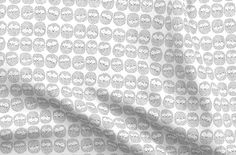 an image of a white fabric with black and white circles on the side, as well as