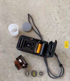 a camera and two batteries on the ground