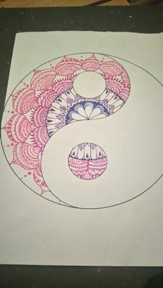 a drawing of a yin - yang symbol is shown on a piece of white paper