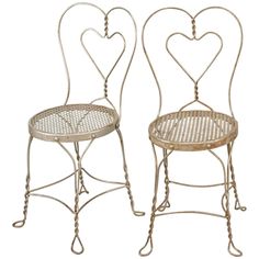 two metal chairs with hearts on them