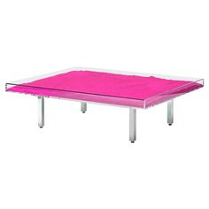 a pink table with metal legs and a glass top on the bottom, in front of a white background