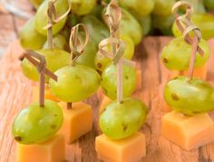 grapes and cheese are arranged on small sticks