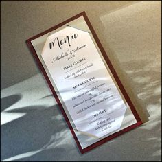 a menu card with the name and date on it sitting on top of a table