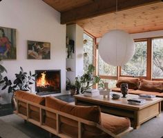 a living room filled with furniture and a fire place in the middle of a room