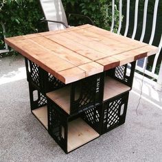 an outdoor table made out of wood and metal