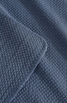 closeup of the texture of a blue quilt