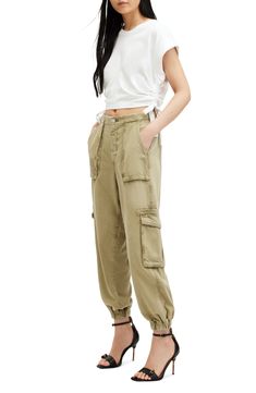 Joggers with exaggerated pockets deliver a modern-utility look that's surprisingly polished. The drapey, slightly stretchy fabric delivers a perfectly slouchy fit and makes the style really comfortable, too. 26" inseam; 12" leg opening; 11 1/2" front rise; 16" back rise (size 8) Zip fly with button closure; back elastic waist Front slant-patch pockets; cargo flap-patch pockets 60% cotton, 40% lyocell Machine wash, line dry Imported Casual Spring Allsaints Bottoms, Allsaints Relaxed Fit Bottoms For Spring, Spring Utility Mid-rise Parachute Pants, Versatile Spring Cargo Pants For Elevated Casual Wear, Spring Parachute Pants With Flap Pockets, Allsaints Casual Bottoms For Fall, Utility Bottoms With Cargo Pockets For Elevated Casual, Allsaints Casual Fall Bottoms, Spring Utility Parachute Pants