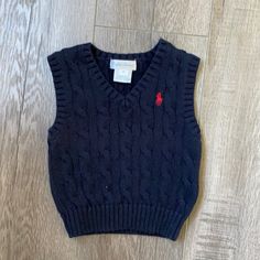 Ralph Lauren Cable-Knit Cotton Sweater Vest - Blue With Red Logo This Layering Piece Is Cable-Knit From Soft Combed Cotton And Finished With Embroidery Of Our Signature Pony. Washed But Never Worn Cute Cotton Cable Knit Sweater, Navy Cable Knit Cotton Top, Navy Cotton Cable Knit Top, Navy Cotton Sweater Vest For Winter, Navy Fitted Knitted Top, Navy Cotton Casual Sweater Vest, Fitted Cotton Cable Knit Sweater Vest, Casual Navy Cotton Sweater Vest, Navy Cotton Cable Knit Sweater