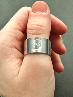 It's a Hoosier thing; no matter where you go Indiana is always in your heart! Each one is hand stamped here at home here in Indiana, and is sure to keep a little piece of the Hoosier State with you no matter where you go!  This ring is adjustable between, approximately, size 7 through 9! Made of high quality aluminum, it is incredibly lightweight without sacrificing durability! It is the perfect accessory for every day or any occasion! Morgan Wallen Simple Rings, Thick Ring, Stamped Rings, Wave Ring, Spoon Rings, Hand Stamped Jewelry, Star Ring, Personalized Rings, Stamped Jewelry