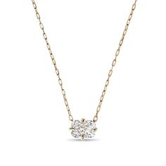 a diamond necklace on a chain with a gold tone finish and an oval cut stone in the center