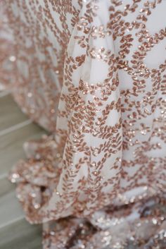 the back of a dress with gold sequins on it's sleeves and bottom