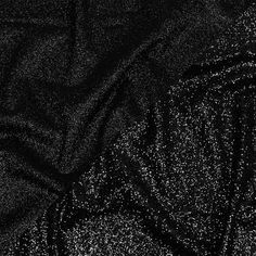 There is nothing more timeless than this Gala Black Double Faced Glitter Tulle. A black tulle base is adorned with black glitter on both sides, with one side showing a finer glitter than the other. The crisp hand and weighted drape make it an excellent choice for evening gowns, skirts, ball gowns, and bold capes, or use it for special occasion dresses, such as for weddings or quinceañeras. Opaque, a lining can be used for comfort if desired. Mood Designer Fabrics, Black Tulle, Black Mesh, Black Glitter, Black Fabric, Special Occasion Dresses, Evening Wear, Evening Gowns, Special Occasion