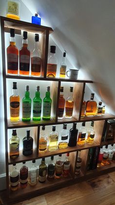 a shelf filled with lots of different types of liquor