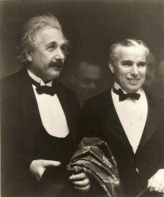 two men in tuxedos are posing for a photo