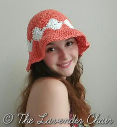 a girl wearing a crocheted hat with flowers on it