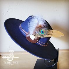 If you’re looking for the perfect accessory to complement your favorite boho style, look no further. This Boho-Style Western Felt Hat w/ Natural Feather & Turquoise Hat Accent by The Jewelry Junkie is absolutely everything that you need. Not only is it easy to incorporate into any and all outfits, but the genuine leather and natural feathers of the band immediately elevate whatever it is you’re wearing. One Size Hat with adjustable inner hat liner (see last photos) The same primary feathers will Blue Bohemian Felt Hat With Short Brim, Bohemian Blue Felt Hat With Short Brim, Bohemian Blue Short Brim Felt Hat, Blue Bohemian Wide Brim Felt Hat, Bohemian Blue Wide Brim Felt Hat, Blue Wide Brim Bohemian Felt Hat, Blue Bohemian Felt Hat For Festival, Blue Bohemian Fedora With Short Brim, Unique Blue Adjustable Hat