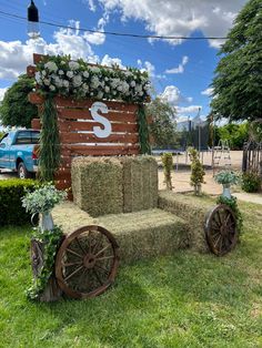 a horse drawn hay cart with flowers on it