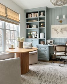 a living room filled with furniture next to a window covered in bookshelves and windows