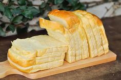 a loaf of bread cut in half on a cutting board