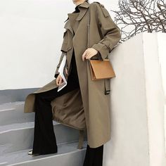 Look sharp and stay dry in this army green asymmetric trench coat! Featuring shoulder epaulets and a trendy belted waist, you'll be the chicest one around town even in the rainiest of days. Button up the gun flap for extra coverage, and voilà – you're ready for a stylish adventure! Long sleeves Spread collar with button belt Button gun flap Belted cuffs Front welt pockets Removable tie belt Lined Cotton, polyester Machine wash, tumble dry Item #310265 SIZE INFO XS=US2=UK6=EU32 S=US4-6=UK8-10=EU3 Spring Outerwear With Belt, Casual Winter Outerwear With Belt, Double-breasted Belted Fall Outerwear, Fall Double-breasted Outerwear With Belt, Khaki Belted Long Coat, Fall Double-breasted Belted Outerwear, Trendy Belted Outerwear For Winter, Khaki Belted Double-breasted Outerwear, Khaki Belted Utility Outerwear