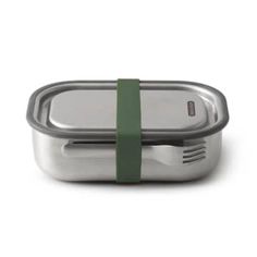 a stainless steel container with a green band around the lid and spoon in front of it