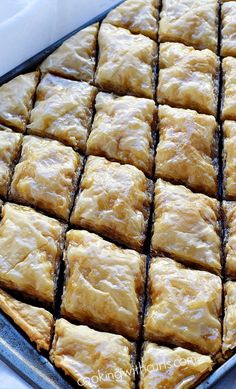 a pan filled with baked pastries sitting on top of a table