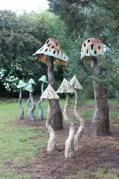 some very pretty little trees with mushrooms on it's tops in the grass and dirt