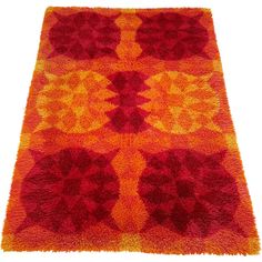 an orange and red rug on a white background