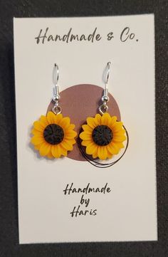 Delicately made polymer clay sunflower. Each one is slightly unique due to the handmade nature, but each consistently showcase a beautiful sunflower. Metal findings are sterling silver, and all our jewelry is lead and nickel free! Sunflower Design Dangle Earrings For Gift, Sunflower Design Dangle Earrings As Gift, Yellow Sunflower Dangle Earrings, Yellow Sunflower Design Dangle Earrings, Yellow Sunflower Design Earrings As Gift, Yellow Sunflower Design Flower Earrings As Gift, Yellow Polymer Clay Earrings With Ear Wire, Hypoallergenic Flower-shaped Polymer Clay Jewelry, Yellow Flower-shaped Polymer Clay Earrings