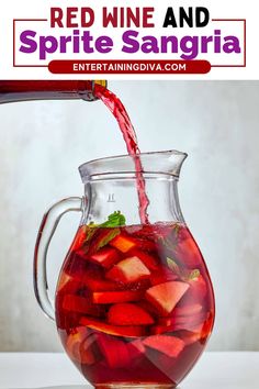 red wine being poured into a pitcher filled with sangria