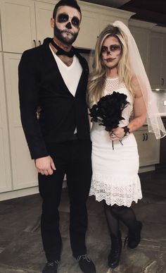 a man and woman in skeleton makeup pose for a photo while dressed up as bride and groom