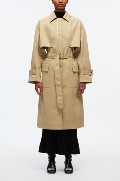 Distilled with a nonchalant spirit, this coat riffs on the classic trench. It's cut from cotton twill to a relaxed silhouette accentuated by hallmark details like storm flaps, a belted waist and button tabs at the cuffs. Adjust the zip at the chest for convertible styling. Cotton twill Point collar Long sleeves with bu Classic Khaki Outerwear With Belted Cuffs, Classic Khaki Belted Outerwear, Spring Gabardine Outerwear With Belt Loops, Spring Cotton Outerwear With Belt Loops, Belted Beige Cotton Outerwear, Khaki Belted Gabardine Outerwear, Khaki Gabardine Belted Outerwear, Oversized Belted Gabardine Outerwear, Classic Spring Outerwear With Belt Loops