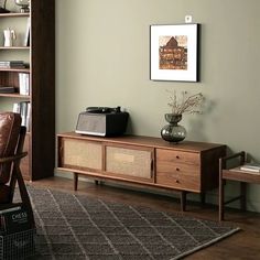 a living room with a brown couch and wooden furniture