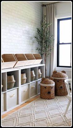 a living room filled with lots of storage and baskets on top of it's shelves