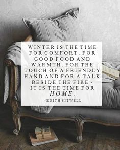 a couch sitting in front of a wall with a quote about winter is the time for comfort