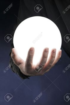 a man holding a glowing ball in his hand stock photo - 957982