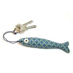 a fish shaped key chain with two keys attached to it