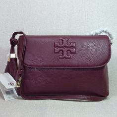 Brand New Never Been Carried. Last Piece In Stock. Thea Messenger By Tory Burch. This Bag Is Made Of Cabernet Pebbled Genuine Leather. This Bag Is Perfect As A Daily Use Bag. Dimensions: 10.5" Wide Across Bottom X 8" Tall Center X 3.75" Deep. Long Strap Maximum Length 53". Flap Closure Single Compartment Interior: 1 Zipper Pocket And 2 Slip Pockets 1 Slip Pocket At The Back Of The Bag For Your Keys Or Phone. Fabric Lining. Gold Tone Metalware. Outlet Item Doesn't Come With Dust Bag But Will Prov Tory Burch Crossbody Handbags, Leather Crossbody Bag Tory Burch, Tory Burch Messenger Bag, Tan Textured Leather Crossbody Bag, Tory Burch Bag, Kate Spade Crossbody, Pebbled Leather, Red Gold, Cross Body