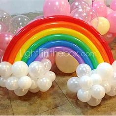 a rainbow balloon arch with white balloons