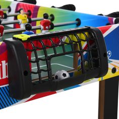 several colorful foosball tables with soccer balls on them