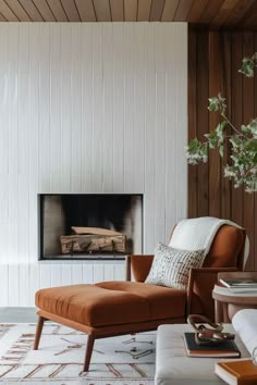 a living room with a couch, chair and fireplace