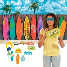 a woman holding up a sign with surfboards behind her