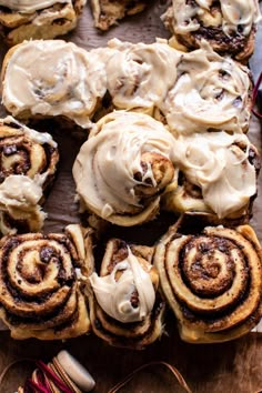 cinnamon rolls with icing on a wooden board