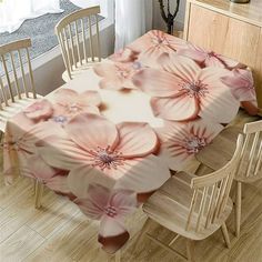 a dining room table covered with pink flowers