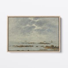 a painting hanging on the wall next to a white wall with an ocean scene in it