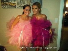 two women dressed in pink dresses posing for the camera