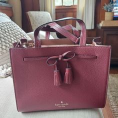 Burgundy Kate Spade New York Hayes Street Satchel With Bow Detail, Handles, Cross Body Strap, Zipper Compartment, And Interior Pocket. New With Tag. Bow Detail, Cross Body, Satchel, Kate Spade, Handles, New York, Zipper