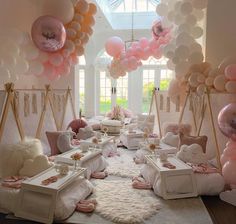 a room filled with lots of balloons and furniture