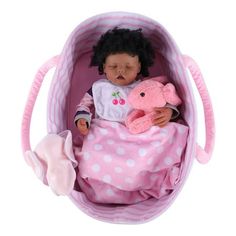 a baby doll is laying in a pink basket