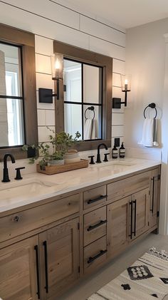 a large bathroom with double sinks and mirrors